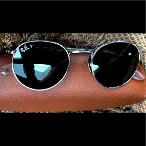 Round, titanium, silver frame, crystal lens, polarized black. Great Condition.